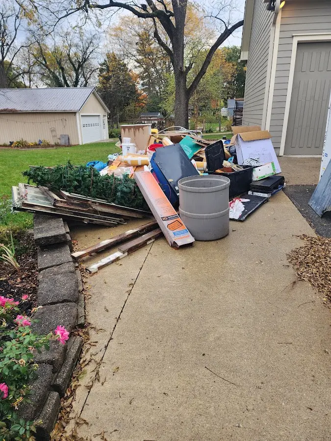 Dumpster being loaded with debris for Estate Cleanout Dumpster Rental in University Heights
